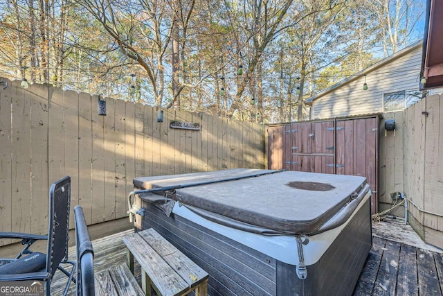 wooden terrace featuring a hot tub