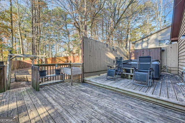 wooden deck with a hot tub