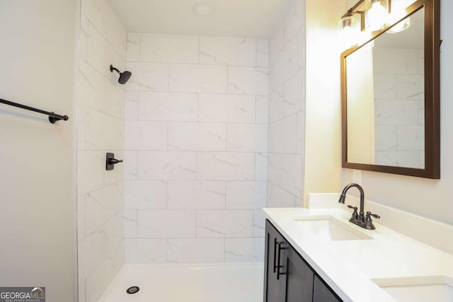 bathroom featuring vanity and a tile shower