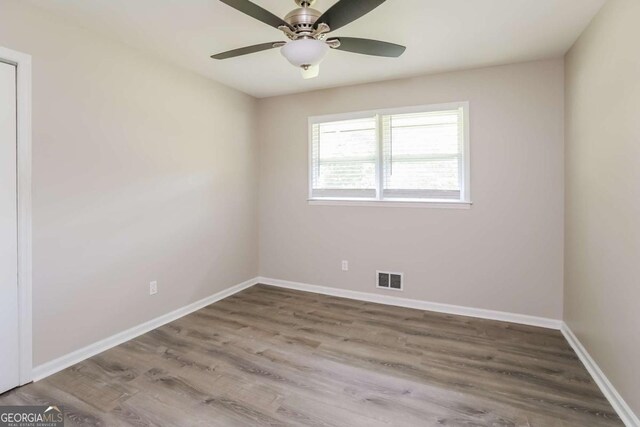 unfurnished room featuring hardwood / wood-style flooring and ceiling fan