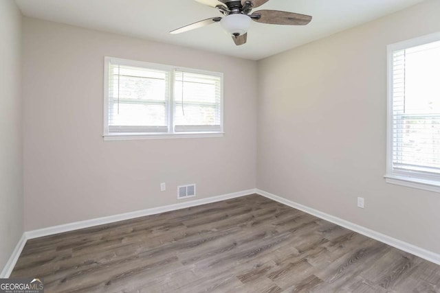 empty room featuring ceiling fan and wood-type flooring