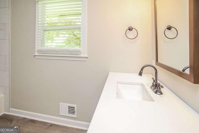 bathroom featuring vanity and hardwood / wood-style flooring