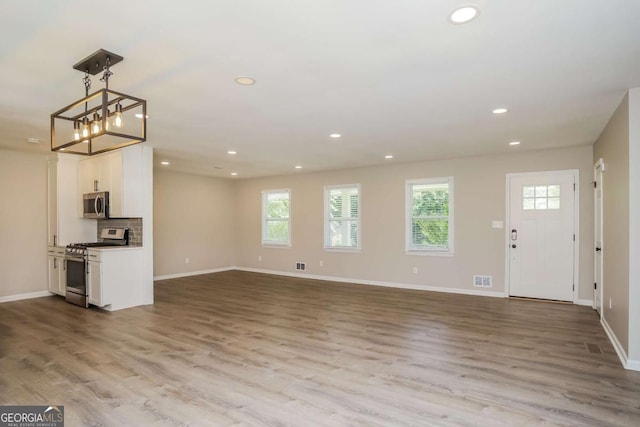 unfurnished living room featuring light hardwood / wood-style flooring