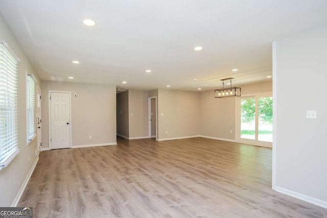 empty room with light hardwood / wood-style flooring