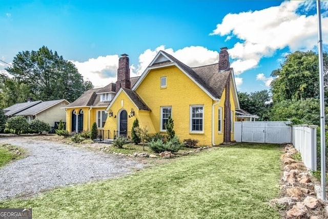 back of house with a lawn