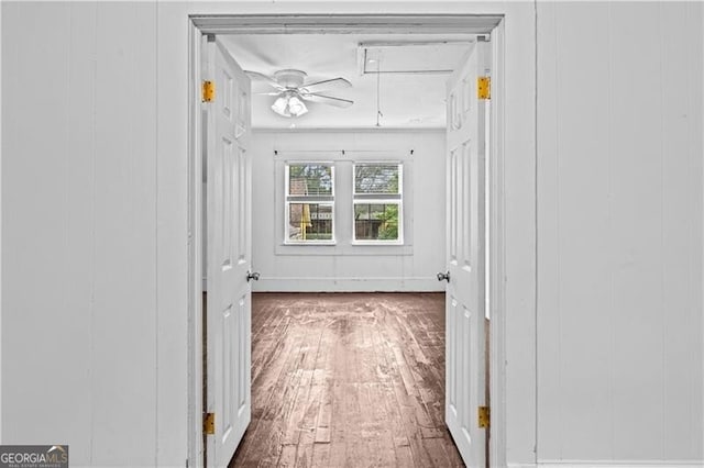 interior space featuring white cabinets, wood walls, and a textured ceiling