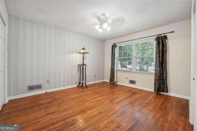 empty room featuring hardwood / wood-style flooring and ceiling fan