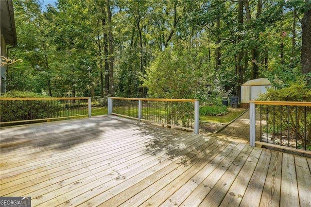 wooden terrace with a storage shed