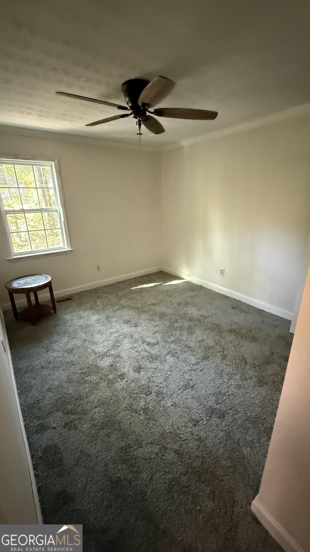 carpeted empty room with ceiling fan and crown molding