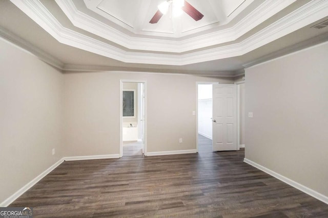 empty room featuring dark hardwood / wood-style floors, a raised ceiling, ceiling fan, and crown molding