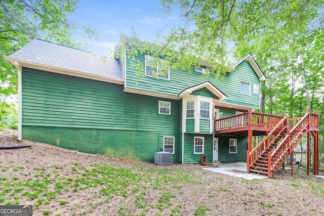 back of house featuring central AC and a deck