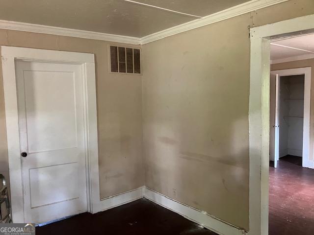 spare room with crown molding