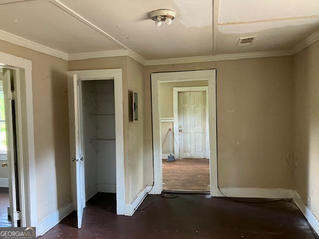 interior space featuring dark hardwood / wood-style floors and crown molding