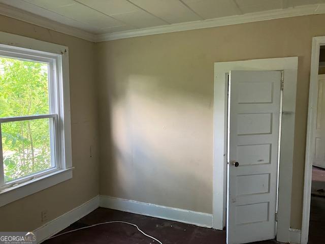 spare room featuring ornamental molding