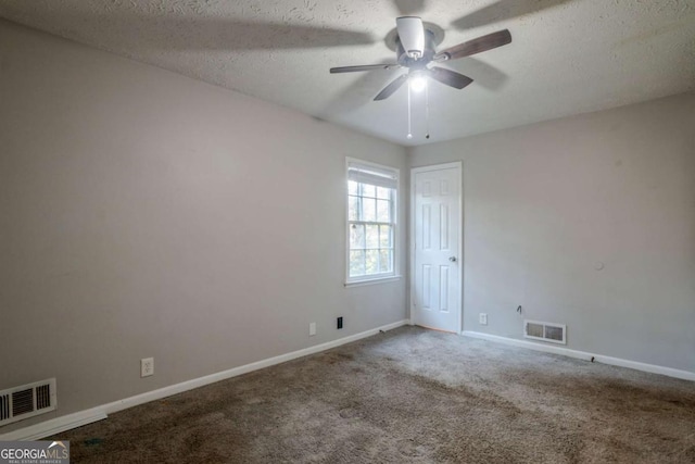 carpeted empty room featuring ceiling fan and a textured ceiling