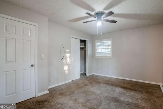 unfurnished bedroom featuring ceiling fan, carpet floors, and a textured ceiling