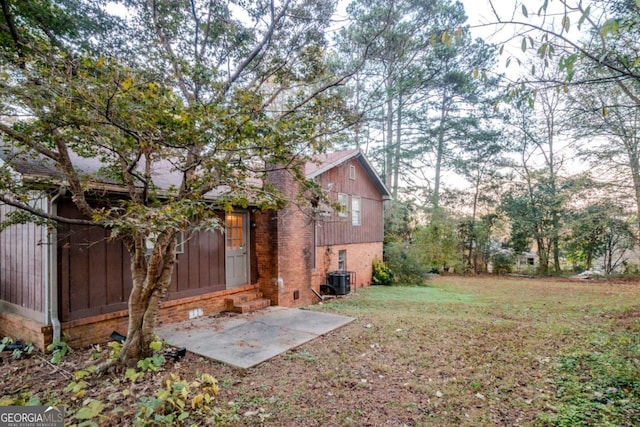 view of yard featuring a patio and central AC