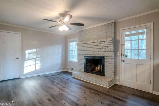 unfurnished living room featuring dark hardwood / wood-style floors, ornamental molding, and a wealth of natural light