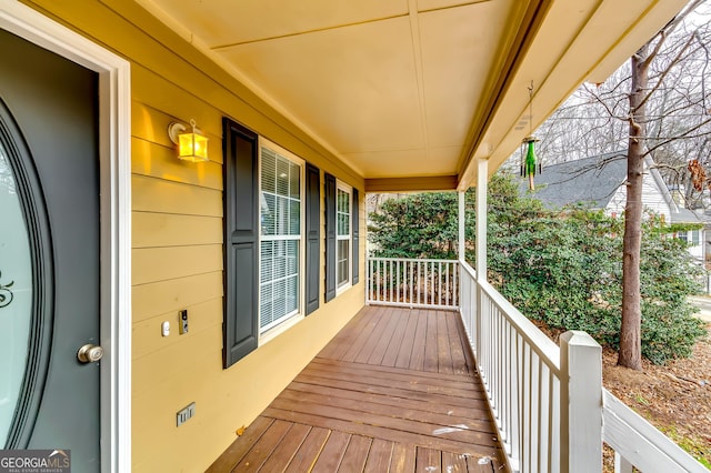 wooden terrace featuring covered porch