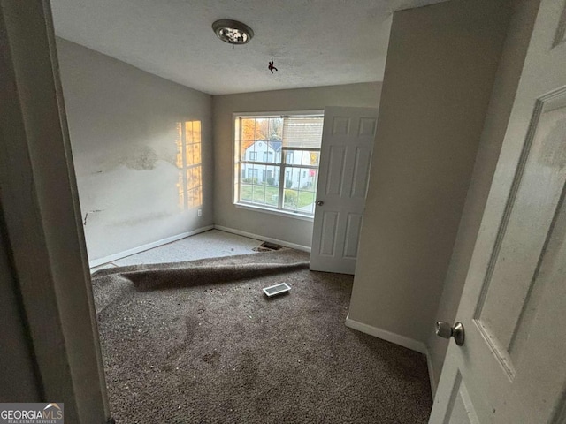 5830 Burdett Rdg, Atlanta, GA 30349 - spare room with carpet floors and a textured ceiling