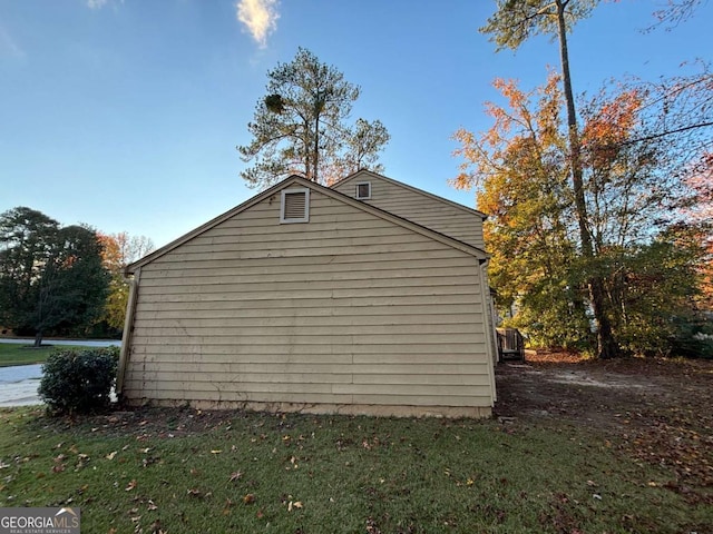 view of side of property with a lawn