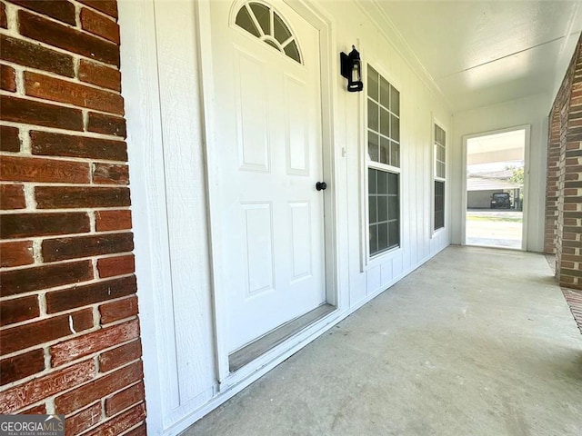 view of exterior entry featuring a porch