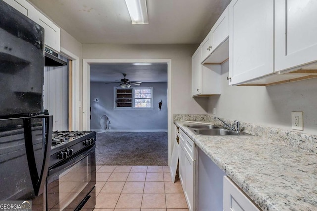 kitchen featuring black appliances, light tile patterned flooring, white cabinetry, and sink