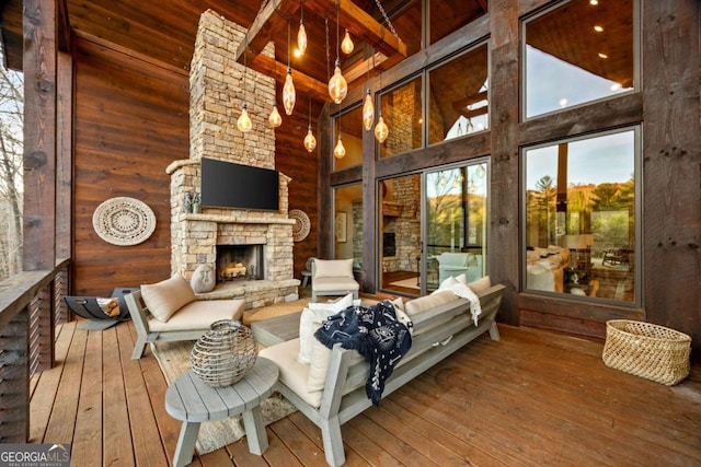 interior space featuring an outdoor stone fireplace and vaulted ceiling with beams