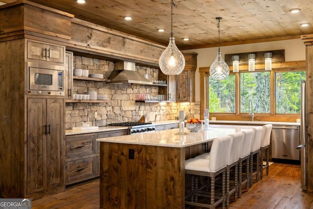 kitchen with a center island, dark wood-type flooring, wall chimney range hood, wood ceiling, and appliances with stainless steel finishes