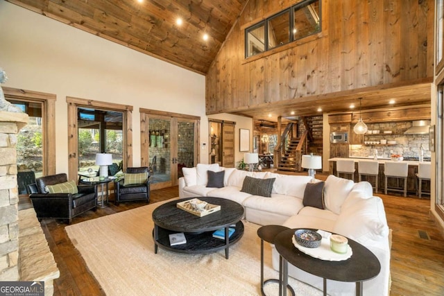 living room featuring dark hardwood / wood-style floors, high vaulted ceiling, and wood ceiling