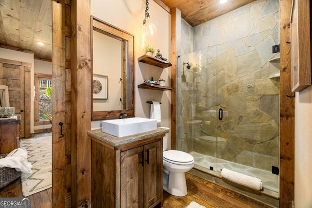 bathroom featuring toilet, a shower with door, vanity, wood ceiling, and hardwood / wood-style flooring