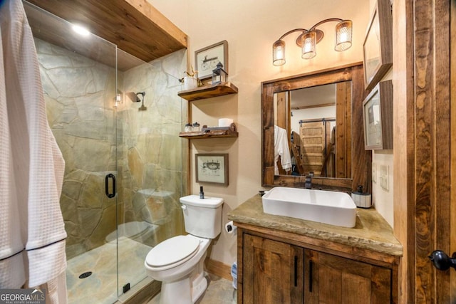 bathroom featuring vanity, toilet, and a shower with door