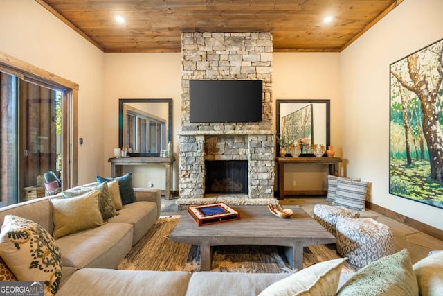 living room with hardwood / wood-style floors, a stone fireplace, and wood ceiling