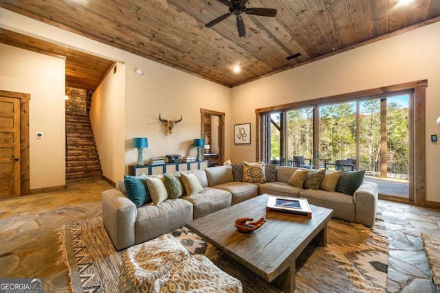 living room featuring ceiling fan and wooden ceiling