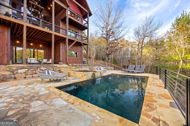 view of swimming pool with a patio area and a hot tub