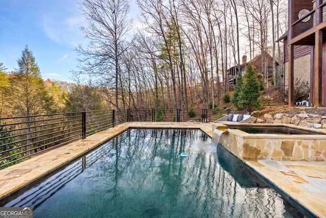 view of pool featuring an in ground hot tub