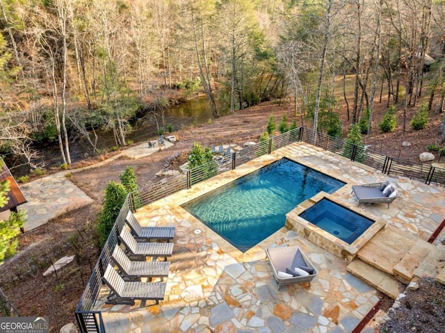 view of pool featuring a patio area and an in ground hot tub