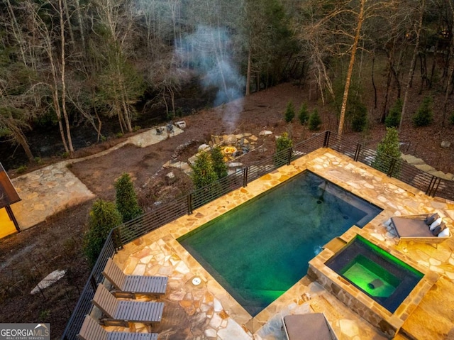 view of swimming pool with an in ground hot tub and a patio