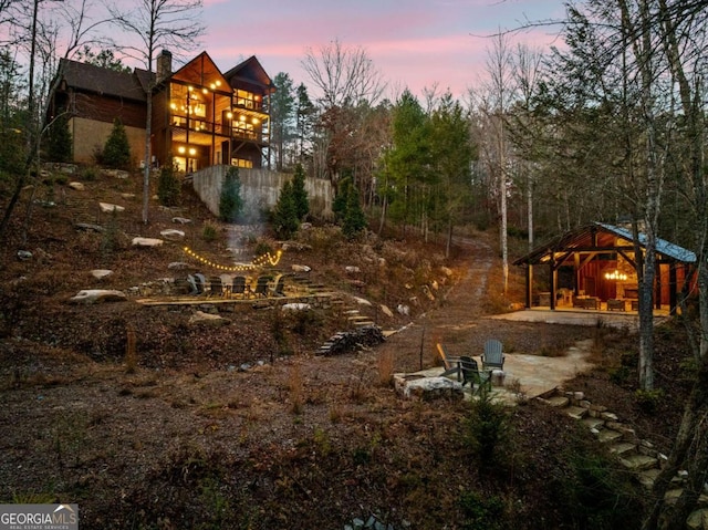 yard at dusk with a balcony