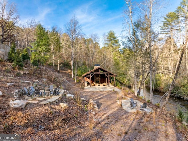 view of yard featuring an outbuilding and a water view