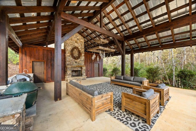 view of patio / terrace with a gazebo and an outdoor living space with a fireplace