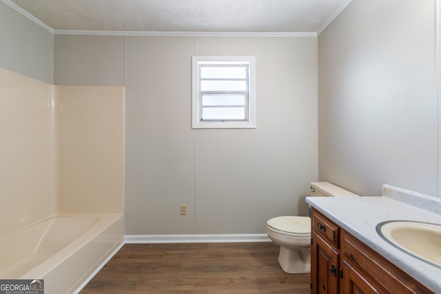 bathroom featuring vanity, toilet, wood-type flooring, and ornamental molding