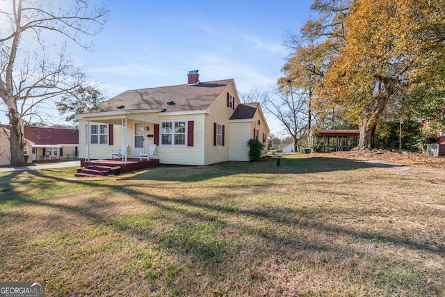 rear view of property with a yard and covered porch