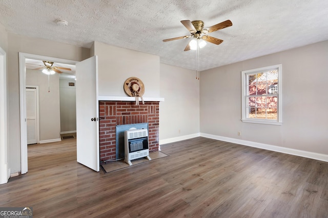 unfurnished living room with ceiling fan, dark hardwood / wood-style flooring, and a textured ceiling