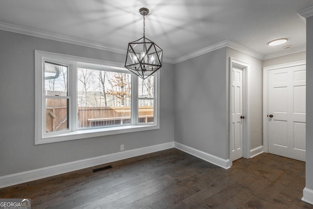 unfurnished dining area with a notable chandelier, crown molding, and dark wood-type flooring