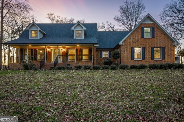 rear view of property with a lawn