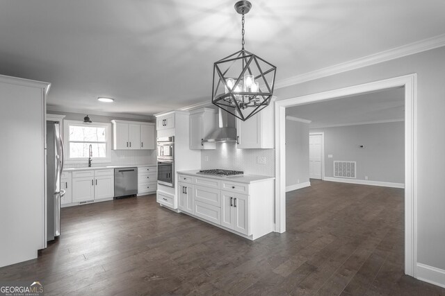 kitchen with white cabinets, stainless steel dishwasher, crown molding, and sink