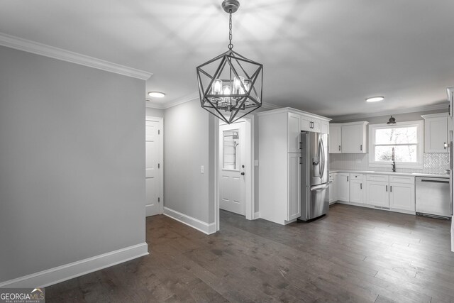 kitchen featuring sink, white cabinets, stainless steel dishwasher, and ornamental molding