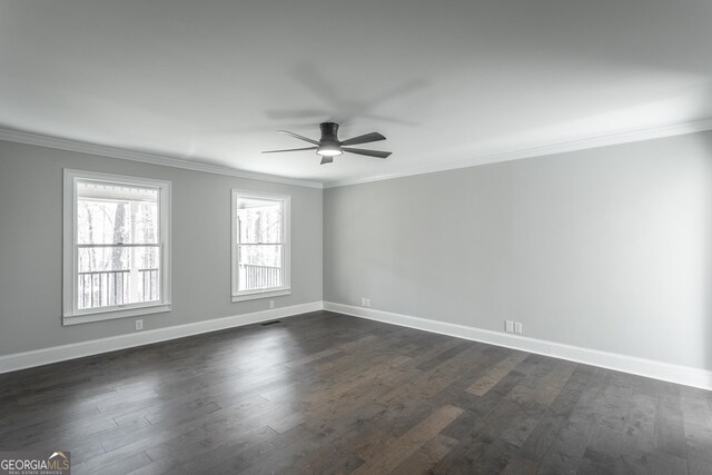 spare room with dark wood-type flooring, ceiling fan, and crown molding