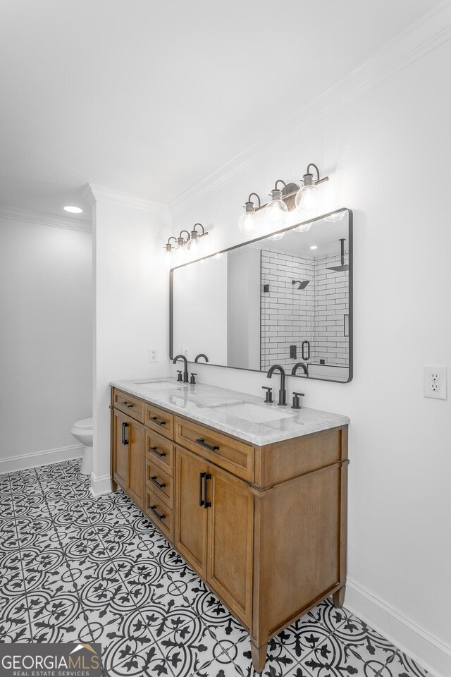 bathroom with tile patterned floors, vanity, and ornamental molding